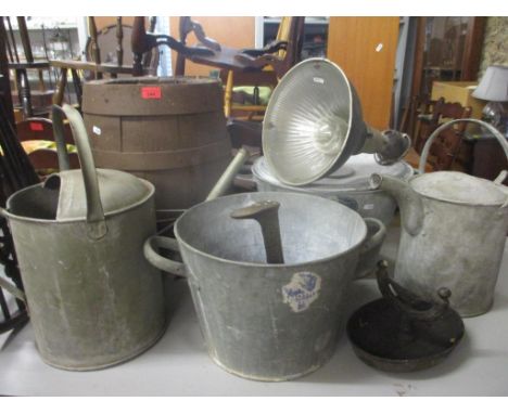 A mixed lot to include vintage tins, a barrel, a boat scraper, a lamp and a selection of stair rods 