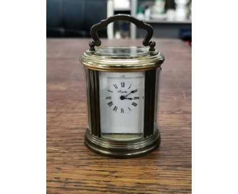 A 20th century oval brass carriage clock by Angelus, with bevelled glass panels and key, 8cmLocation: 5:1 