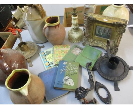A mixed lot comprising stoneware flagons, bird books, metalware, a lamp, clock keys and fruit knives and a small oil on board