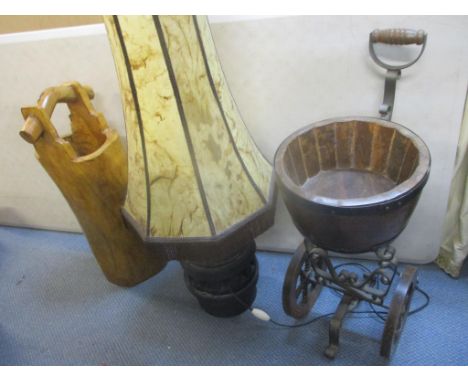 A retro lamp with a tall shade, a hardwood umbrella stand and an oak planter on wheels 