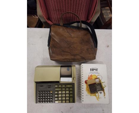 A vintage Hewlett Packard 97 calculator with hand book and original carry caseLocation: 8:3 