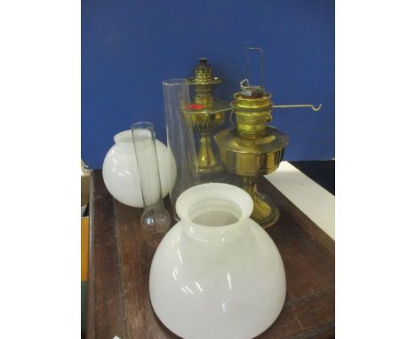 A Victorian brass oil lamp 'The Wizard' with milk glass shade and painted black ceramic base and another oil lampLocation: st