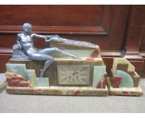 A French marble and cast metal mantel clock surmounted by a woman and peacock 36cm x 53cm, and a side piece 17cm x 16cm 