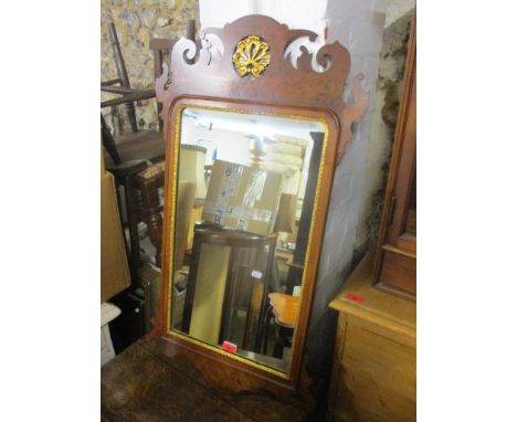 A Titchmarsh &amp; Goodwin reproduction of a George III walnut pier glass with a gilt fretworked crest and panelled glass mir