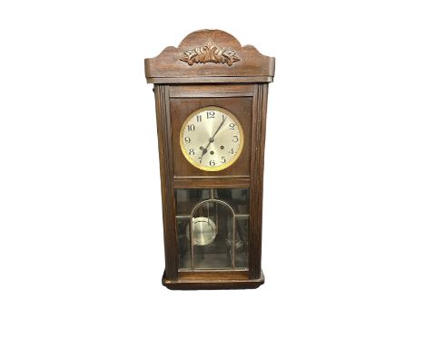Early 20th Century Mahogany Cased Wall Clock. With pendulum and key. Height 77cm Width 32cm. 