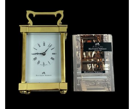 A brass cased carriage clock with bevelled glass panels, Matthew Norman, Swiss Made, complete with key. 