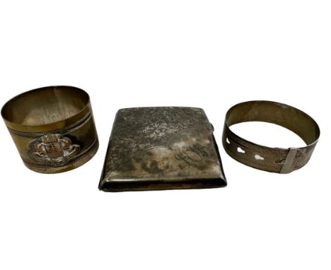 A silver cigarette case (dented and tarnished) and an adjustable silver bangle. Also a trench art Ypres napkin ring. Silver w