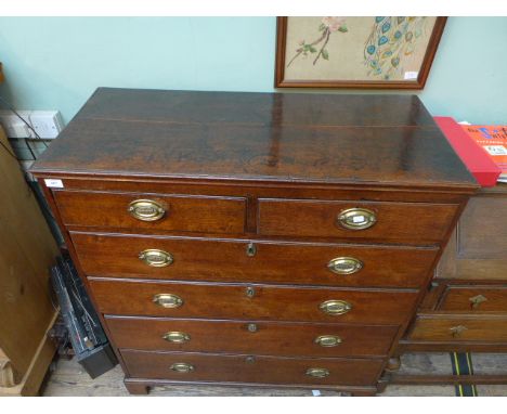 Antique oak chest of two short and four long drawers each with oval brass finger plates and drop handles all on bracket feet
