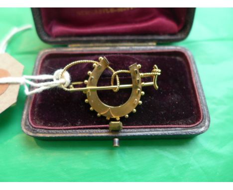 Fine cased horseshoe and crop  scarf brooch, marked 15