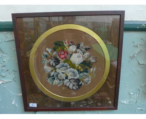 Framed circular panel, tapestry and beadwork of a bowl of coloured flowers