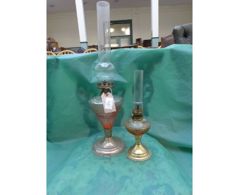 Oil lamp on circular plated plinth and another smaller
