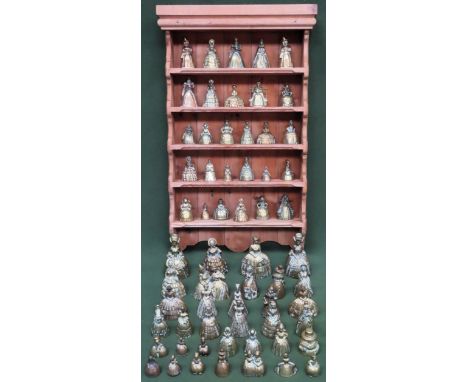 Quantity of various brass crinoline figure form bells, with stripped pine shelf rack All in used condition, unchecked