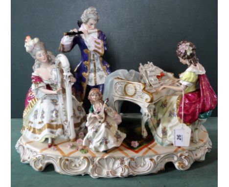 A large Continental porcelain musical figure group, comprising: a seated lady playing a piano, a standing gentleman playing a