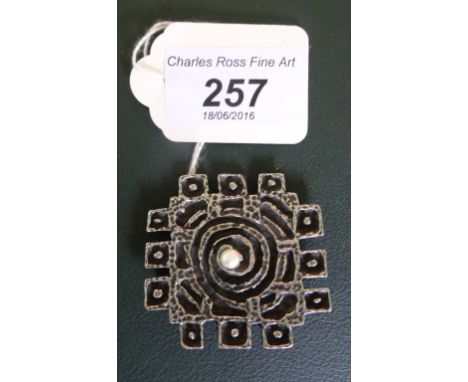 A metal brooch of square abstract form, signed R. Larin.