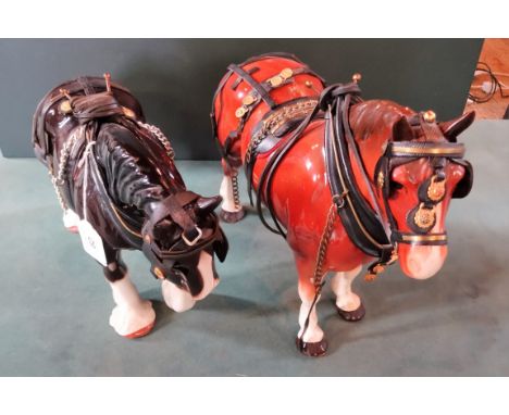A Melwood ceramic model of a shire horse with tack, together with another similar (tallest 29cm).