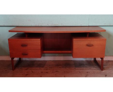 A 1970's G Plan sideboard having single shelf over recessed shelf flanked by two drawers and single cupboard (154cm wide).