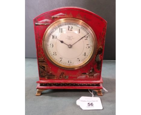 A wooden red painted Japanned mantel clock, the French made movement having enamel dial with Arabic numerals, printed text re