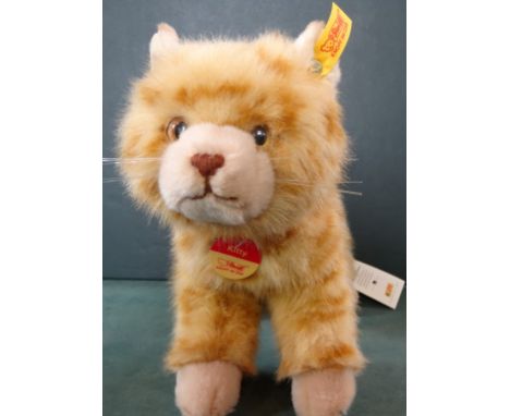A late 20th century Steiff Kitty Cat, paper label, faux leather Steiff collar and brass script button in ear with yellow tag 