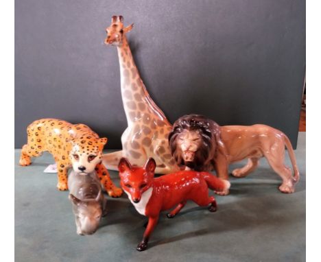 A large Beswick model of a cheetah in gloss finish (29cm long), together with a Beswick fox, a Russian ceramic recumbent gira