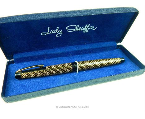 A boxed, vintage, American, black and gold tone (scale motif) fountain pen by Lady Shaffer with a 14 ct yellow gold nib (mark