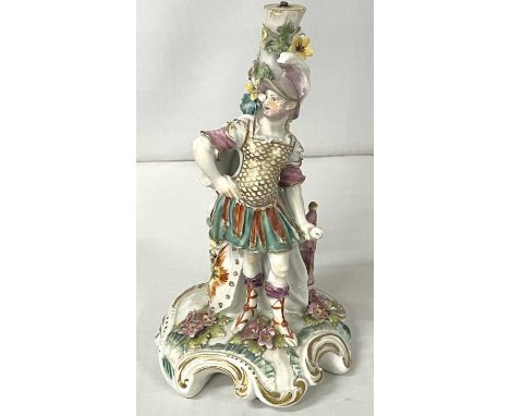 An 18th Century Derby porcelain candlestick figure modelled as a Roman Soldier on shaped base (sconce missing), 20cm high
