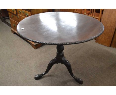 A Georgian mahogany pedestal supper table with circular top with bird cage support, a turned and carved column and a tripod b
