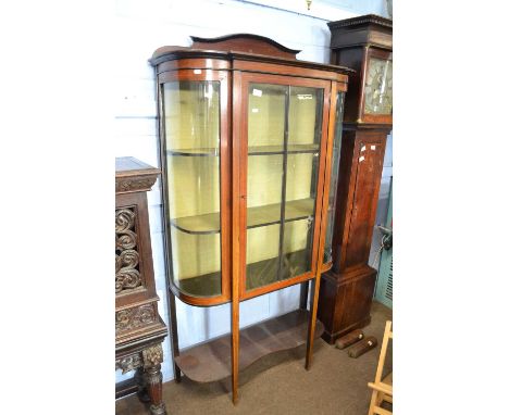 An Edwardian mahogany and line inlaid display cabinet of bow front form with fabric lined interior and tapering legs and a fu