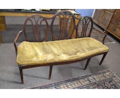 19th Century oak and hardwood sofa with pierced back, cane seat (defective and supported with later board), serpentine front 