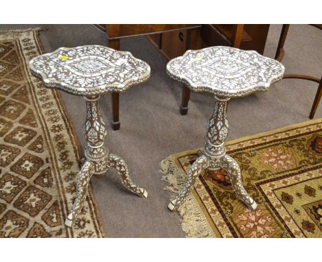 A pair of small Syrian inlaid lamp tables with shaped tops, turned columns and tripod bases, profusely inlaid with geometric 