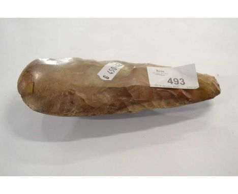 A polished flint axe head presumed from the Neolithic period, 16cm long
