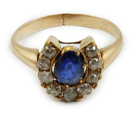 An early to mid 20th century gold, sapphire and diamond set horseshoe cluster ring, size O, gross weight 4.2 grams.**conditio