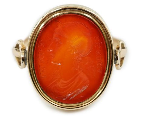 A 19th century gold and intaglio carnelian set oval signet ring, carved with the bust of a lady to dexter and inscribed 'Zeno