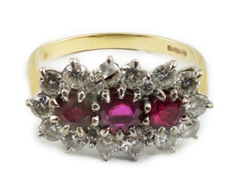 A modern 18ct gold, ruby and diamond set triple cluster ring, size Q, gross weight 4.6 grams.**conditionreport**Good conditio