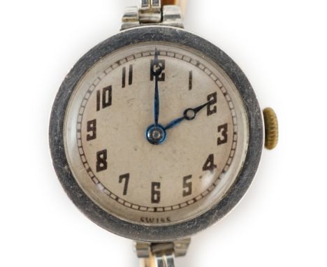 A lady's George V 18ct gold and platinum manual wind wrist watch, with Arabic dial, on a 14ct and platinum flexible bracelet,