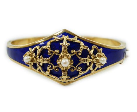 A continental Victorian style 14k gold, blue guilloche enamel and three stone cultured pearl set hinged bangle, interior diam