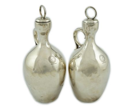 A pair of Victorian silver single handled ovoid water/wine jugs with stoppers, by R &amp; S Garrard &amp; Co, with engraved c
