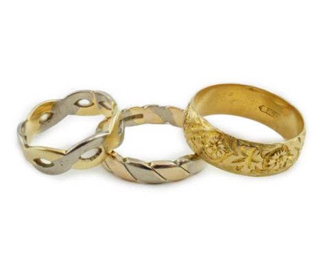 A George V engraved 18ct gold band, size M/N, together with two three or two colour 18ct gold bands, 11.1 grams.**conditionre