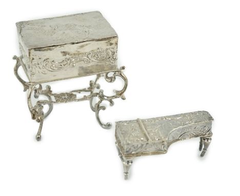 A late 19th century continental embossed silver miniature model of grand piano, length 53mm, together with a similar model of