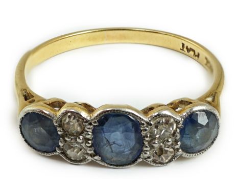 A 1920's 18ct gold and platinum, millegrain set three stone sapphire and four stone diamond half hoop ring, size O, gross wei