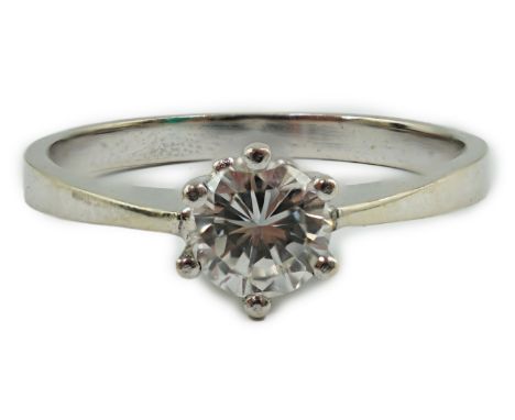 A modern 14k gold and solitaire diamond set ring, the stone measuring 4.9mm in diameter, size N/O, gross weight 2.3 grams.**c