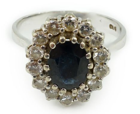 A mid to late 20th century 14k white gold, sapphire and diamond set oval cluster ring, size R/S, gross weight 5 grams.**condi