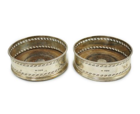 A pair of George V pierced silver mounted wine coasters, by Daniel &amp; John Welby, with turned wooden bases, London, 1910, 