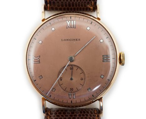 A gentleman's 1950's 18k pink gold Longines manual wind wrist watch, the puce dial with Roman and dot markers and subsidiary 