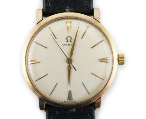 A gentleman's gold Omega manual wind wrist watch, with baton numerals, case diameter 35mm, on a leather strap with Omega 9ct 