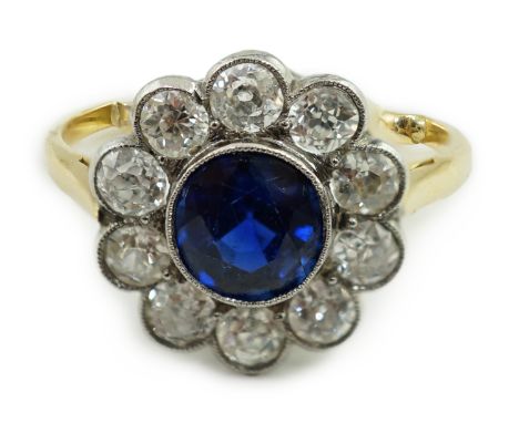 A mid 20th century gold, sapphire and millegrain set diamond flower head cluster ring, size K/L, gross weight 3.2 grams.**con