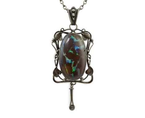 An Art Nouveau silver and oval black opal set drop pendant necklace, with pierced scroll border, pendant 50mm, chain 56cm.**c