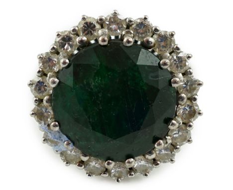 A mid 20th century 18k white gold and round cut emerald set dress ring, with diamond set border, size J/K, gross weight 9.7 g