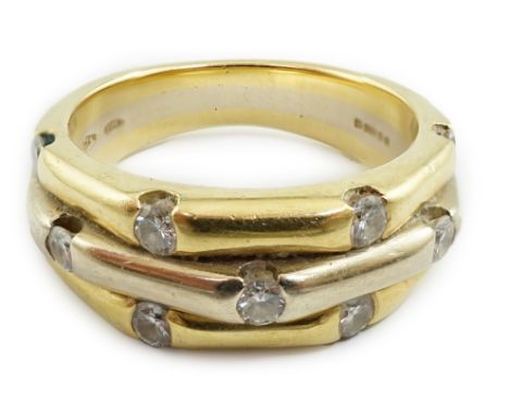 A modern two colour 18ct gold eleven stone diamond set triple shank ring, size L, gross weight 7.9 grams.**conditionreport**M