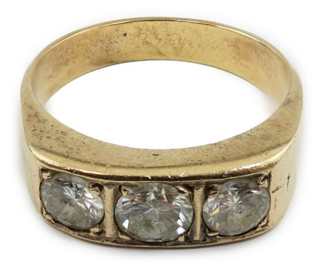 A gold and channel set three stone diamond ring, with a total diamond weight estimated as 1.20-1.30ct, size W/X, gross weight