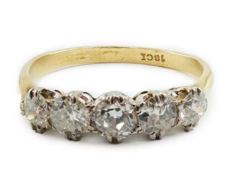 An 18ct gold and graduated five stone diamond set half hoop ring, size U/V, gross weight 4 grams.**conditionreport**One set o